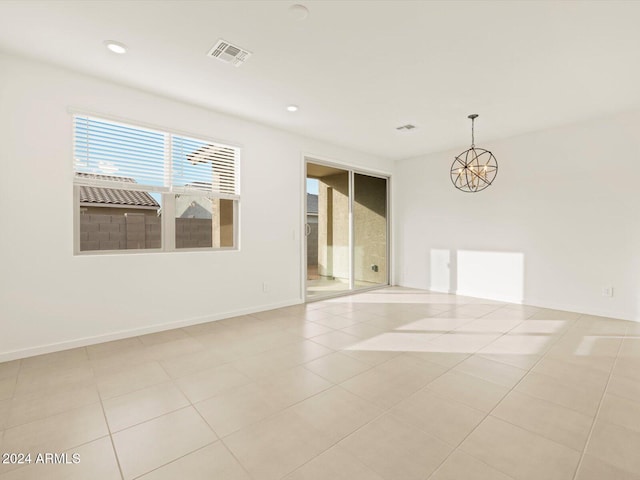 spare room with recessed lighting, visible vents, an inviting chandelier, and light tile patterned flooring