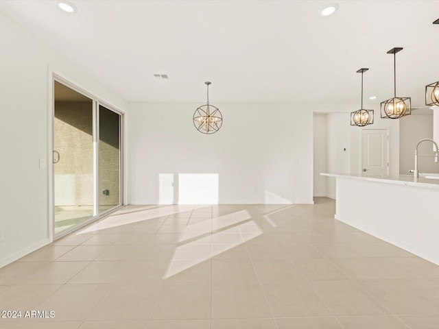 spare room featuring light tile patterned flooring, visible vents, recessed lighting, and a sink