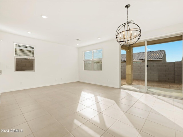 empty room featuring recessed lighting, baseboards, an inviting chandelier, and light tile patterned floors