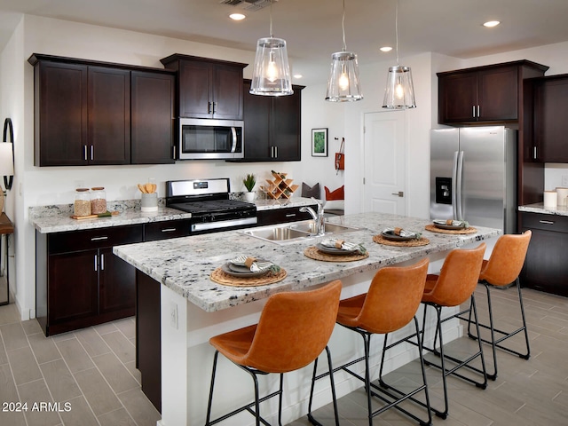 kitchen with visible vents, recessed lighting, a sink, appliances with stainless steel finishes, and a kitchen breakfast bar