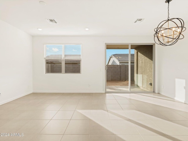 unfurnished room featuring a wealth of natural light, visible vents, and tile patterned flooring