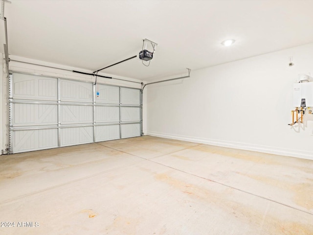 garage featuring a garage door opener, water heater, and baseboards