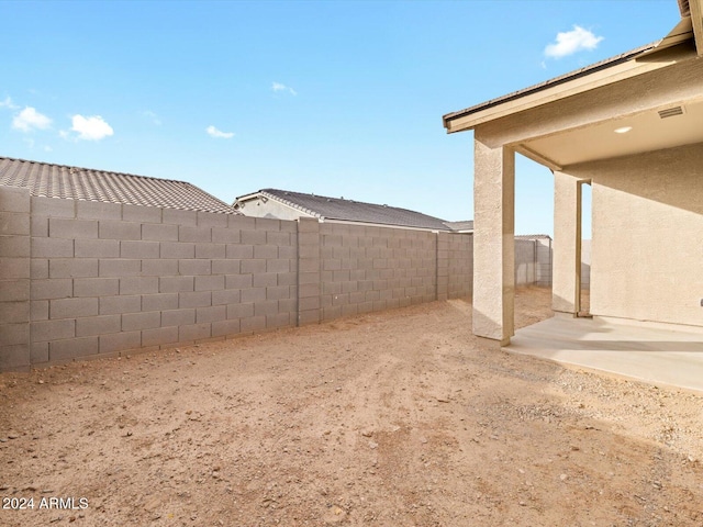 view of yard with a patio area and a fenced backyard