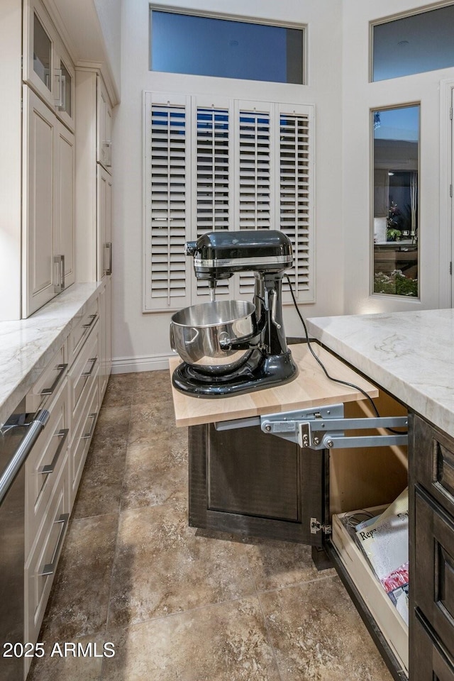 dining space with stone finish flooring and baseboards
