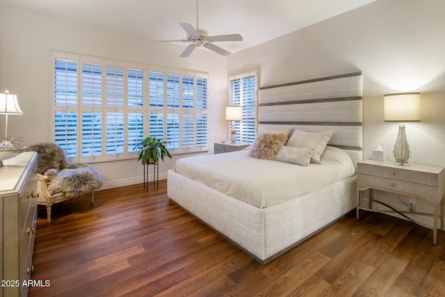 bedroom featuring wood finished floors, baseboards, and a ceiling fan
