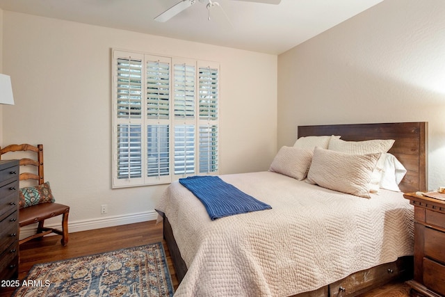 bedroom featuring wood finished floors, baseboards, and ceiling fan