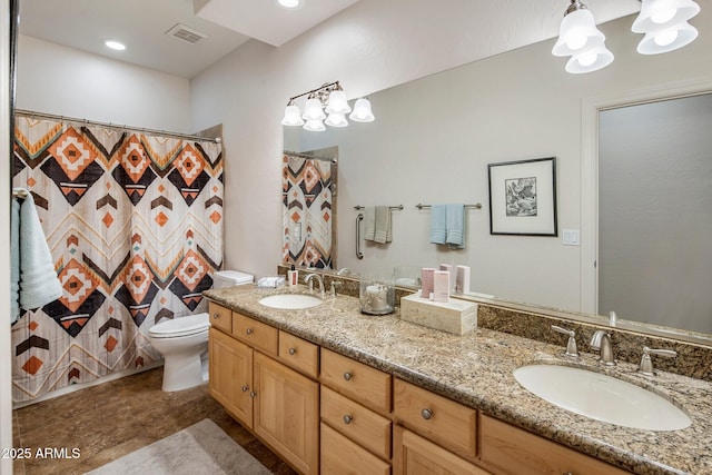 full bathroom featuring a chandelier, toilet, and double vanity
