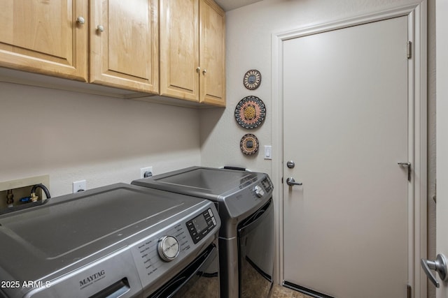 washroom with cabinet space and washer and dryer