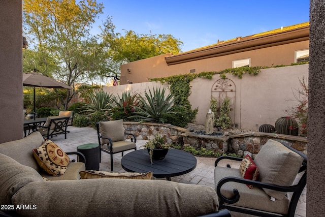 view of patio featuring an outdoor hangout area, a fenced backyard, and outdoor dining space