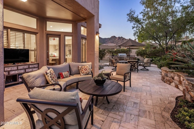 view of patio / terrace with an outdoor living space, a mountain view, and outdoor dining space