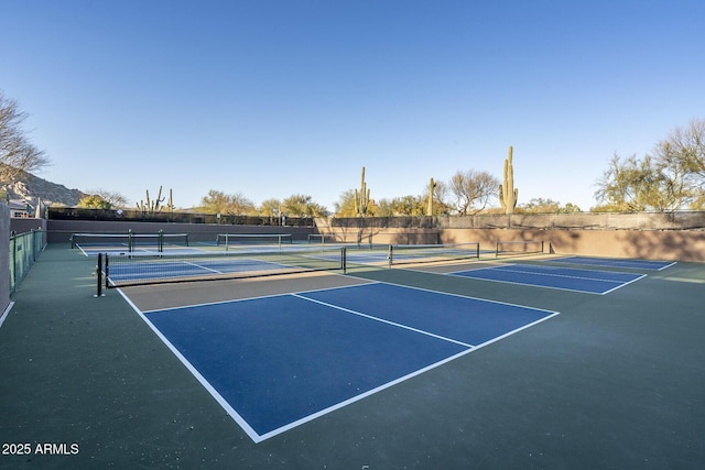 view of tennis court featuring fence and community basketball court