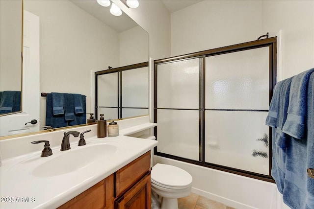 full bathroom with enclosed tub / shower combo, vanity, tile patterned flooring, and toilet