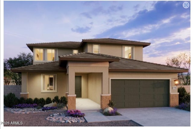 view of front of house featuring stucco siding, a garage, driveway, and brick siding