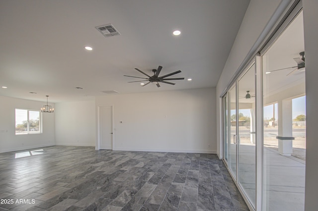 unfurnished room featuring ceiling fan with notable chandelier and dark wood-type flooring