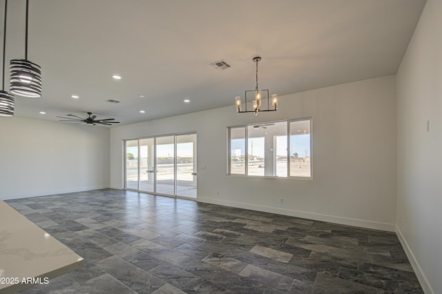 spare room with ceiling fan with notable chandelier