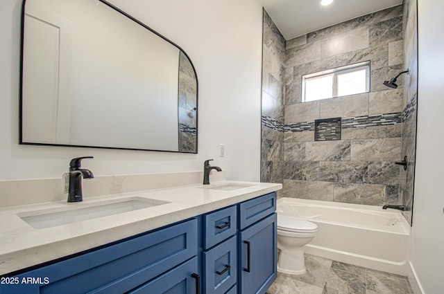 full bathroom featuring toilet, vanity, and tiled shower / bath combo