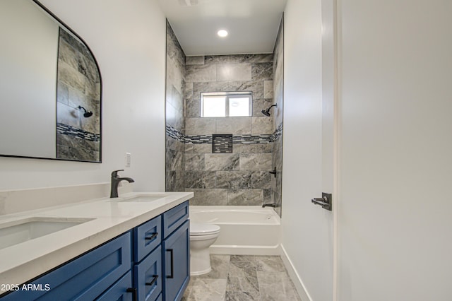 full bathroom with toilet, vanity, and tiled shower / bath combo