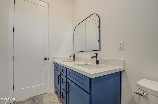 bathroom featuring toilet and vanity