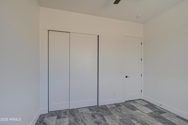 unfurnished bedroom with a closet and ceiling fan