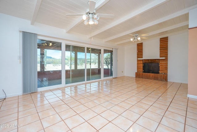 unfurnished living room with a brick fireplace, baseboards, lofted ceiling with beams, light tile patterned floors, and a ceiling fan
