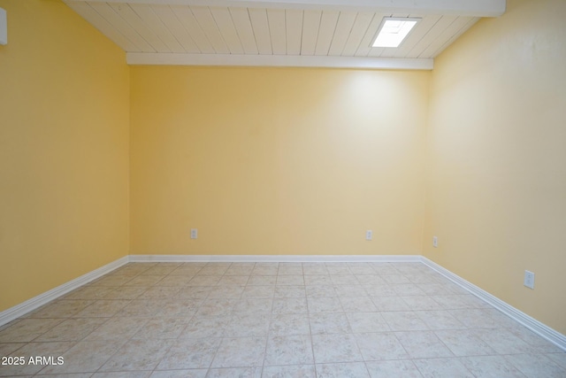 spare room with baseboards