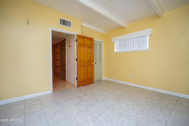 empty room featuring vaulted ceiling with beams, visible vents, wood ceiling, and baseboards
