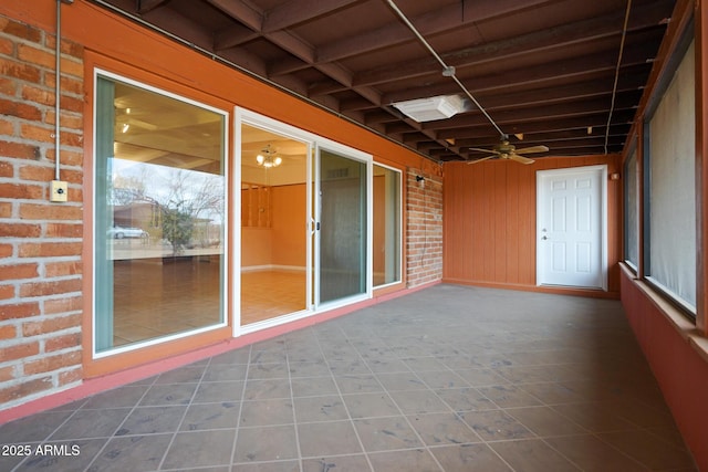 interior space with ceiling fan