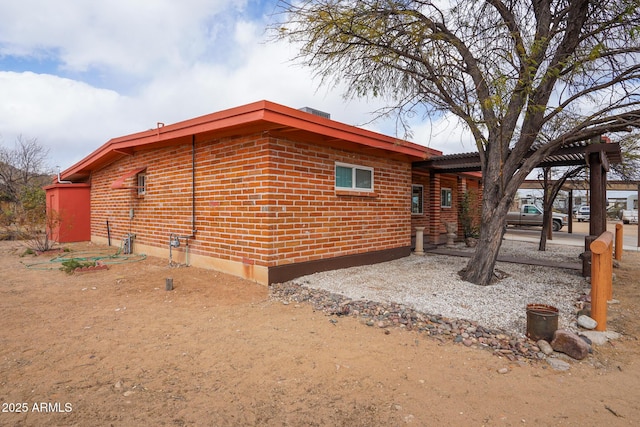 rear view of house featuring brick siding