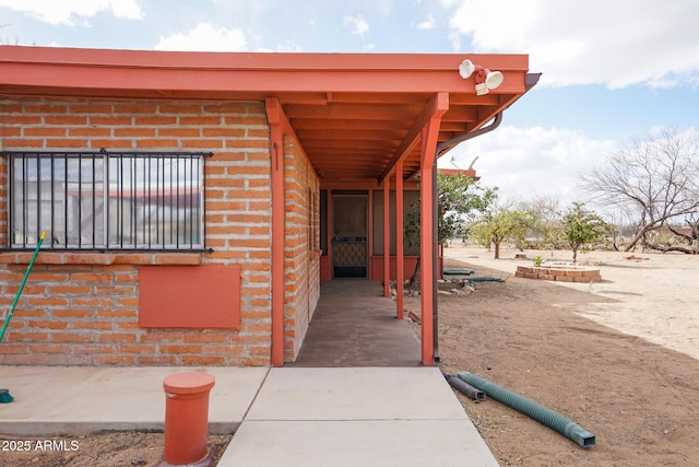 doorway to property with brick siding