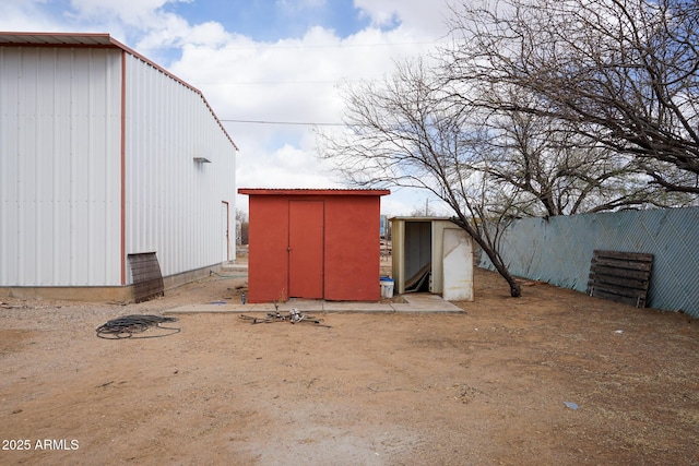 view of shed with fence