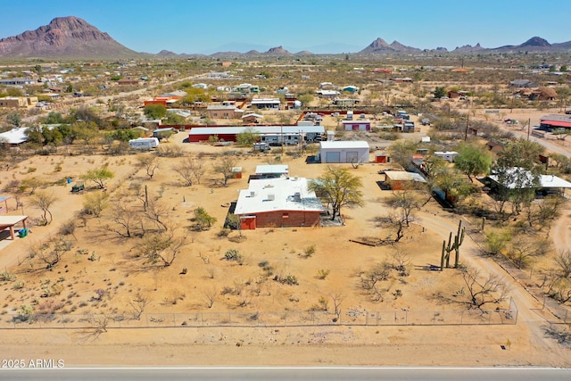 drone / aerial view featuring a mountain view and view of desert