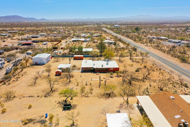 birds eye view of property with a mountain view and view of desert