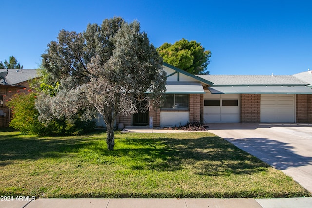 view of front of house with a garage and a front lawn