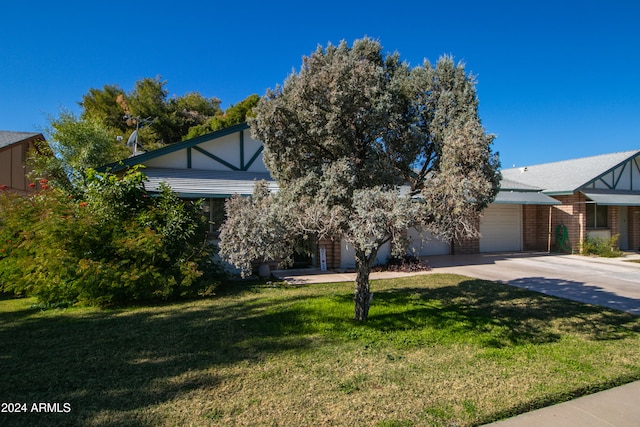 view of front of house with a front yard and a garage