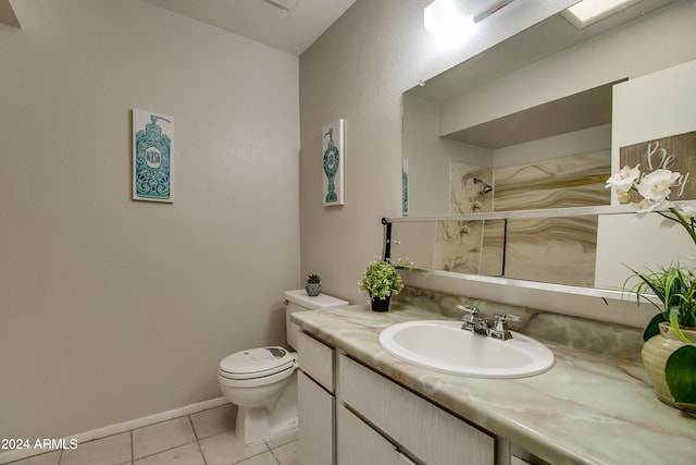 bathroom with tile patterned flooring, vanity, and toilet