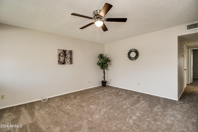 carpeted spare room featuring ceiling fan and a textured ceiling