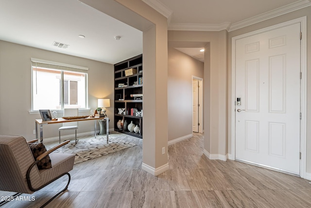 office space with visible vents, built in shelves, baseboards, ornamental molding, and wood finished floors