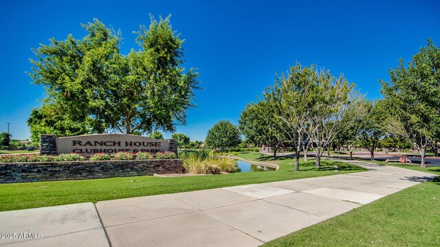 view of property's community featuring a yard and a water view