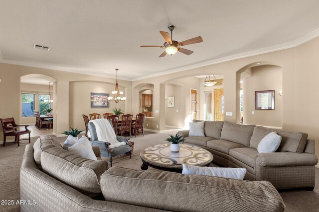 living room with ornamental molding, carpet floors, and ceiling fan with notable chandelier