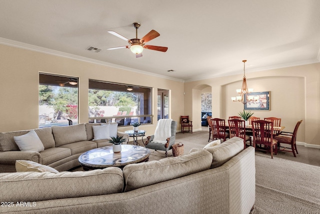 living room with ceiling fan with notable chandelier, carpet flooring, and ornamental molding