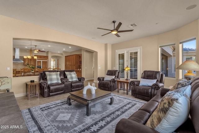 living room with ceiling fan and light tile patterned floors