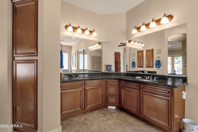 bathroom featuring tile patterned flooring, ceiling fan, and vanity