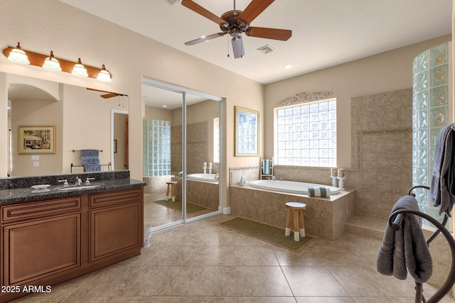 bathroom with ceiling fan, tile patterned floors, independent shower and bath, and vanity