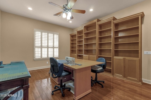 office space with ceiling fan and dark hardwood / wood-style flooring