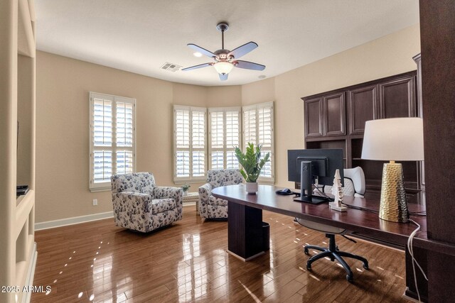 office space featuring ceiling fan and dark hardwood / wood-style flooring