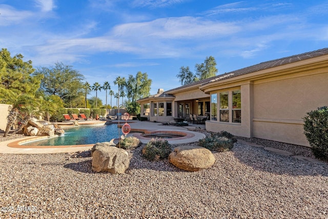 view of pool with a patio and an in ground hot tub