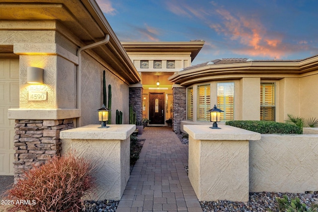 view of exterior entry at dusk