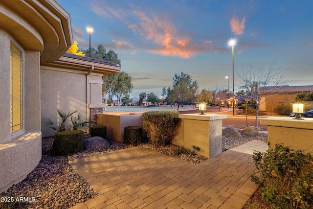 view of patio terrace at dusk