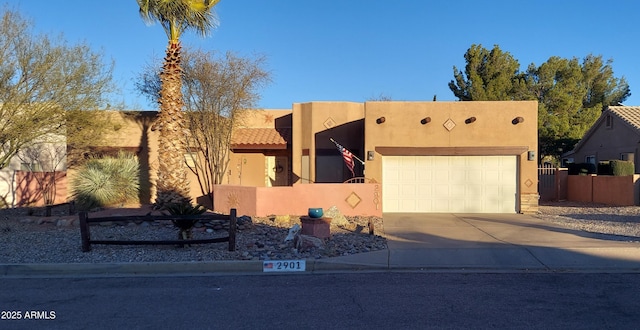 pueblo-style home with a garage