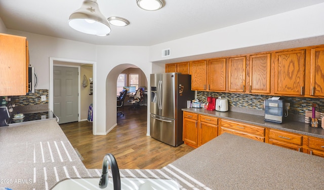 kitchen with sink, decorative backsplash, dark hardwood / wood-style floors, and appliances with stainless steel finishes